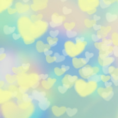 青と緑とピンクのまだら模様のバックに黄色と白のハートの模様の背景