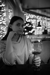 The girl in the evening in a cafe