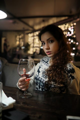 The girl in the evening rest in a cafe