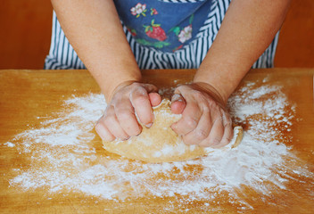 female hands kneading a dough