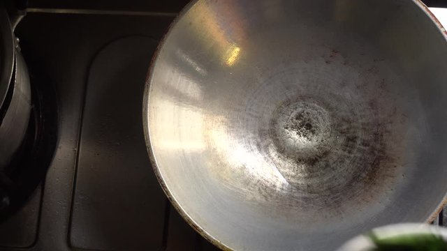 Chef cooking fried Chinese water morning glory, the popular street food in Thailand. Top view and handhelds movement camera in 4K.