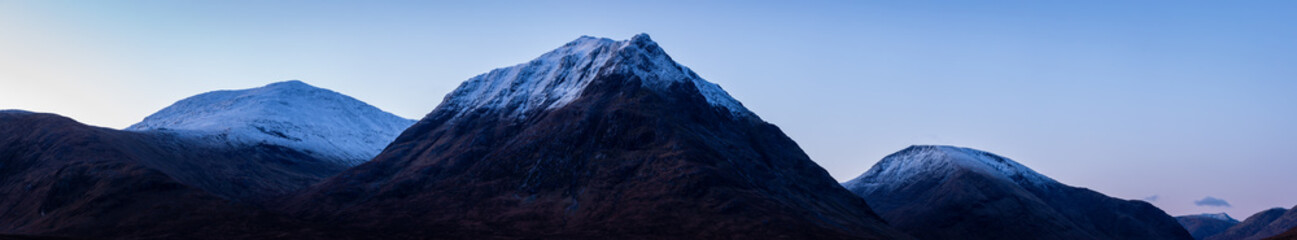 buachaille etive mor and the surrounding mountains of glencoe and rannoch moor in the argyll region of the highlands of scotland during a crisp clear blue winter sunrise © Andy Morehouse