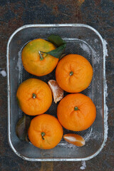 Clementines tangerines  as Christmas decor over snow background