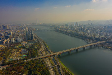 Aerial view of Seoul downtown city skyline with vehicle on expressway and bridge cross over Han river in Seoul city, South Korea.