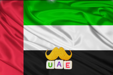 uae real texture flag,uae flag and text written UAE on mustaches meaning strong,waving fabric...