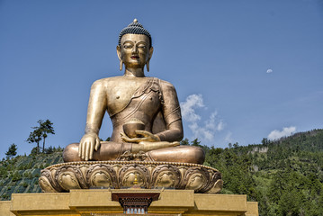 Buddha Dordenma statue in Buthan. The tallest Buddha in the world. Golden Buddha with blue sky and moon in the background.