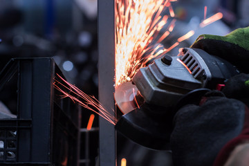 Worker cutting metal in the garage