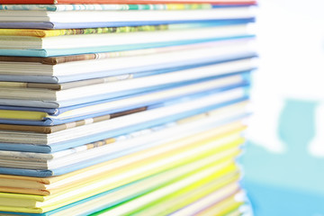 A stack of books. Textbooks on the table. Tutorials are on the desk.