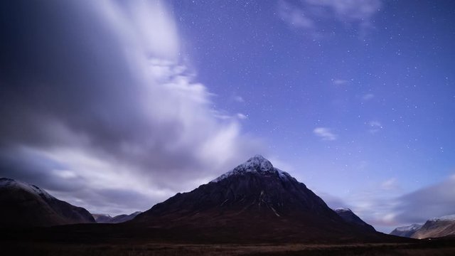 time lapse footage of stars moving above the mountain tops of buachaille etive mor and surrounding mountains in glencoe in the argyll region of the highlands of scotland during winter