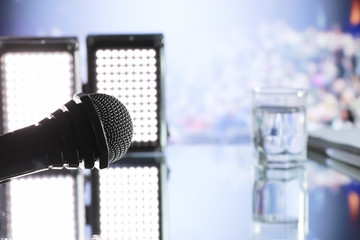The microphone on the stage in front of the hall. Performance on stage.