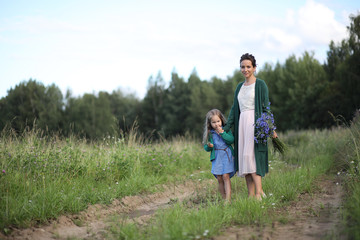 Mother with daughter walking on a road