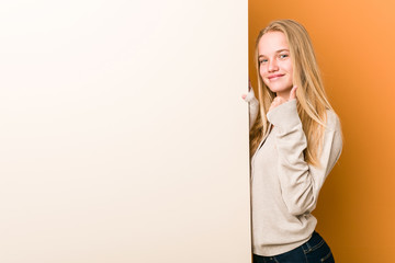 Young caucasian woman with copy space smiling and raising thumb up
