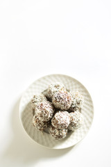 Energy balls on a white bowl on a white background