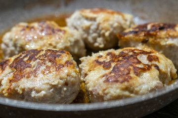 Oil-fried meat cutlets in soft focus 