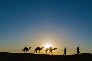 Fototapeta na wymiar Nomads with dromedaries (camels) in the Sahara desert, Morocco.