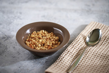 Healthy breakfast. Baked muesli in a grater. Homemade granola in a bowl. Space for text.