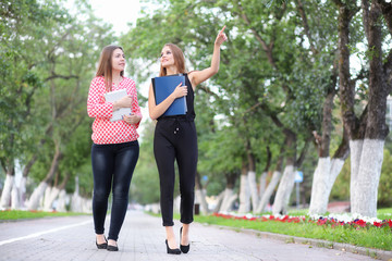 Business meeting of two girls in the park