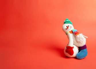 Christmas card. Happy snowman on red background with space for text.