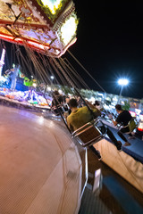 Swinging in theme park at fully lights night
