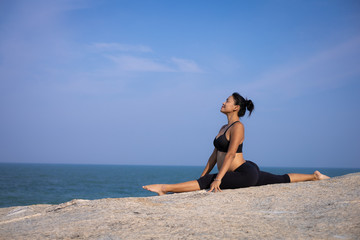  Asian pregnant woman yoga on the beach sunset summer time