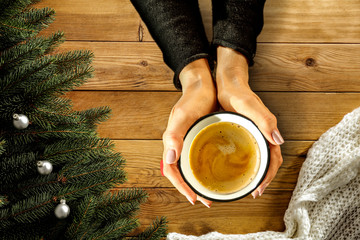 Wooden desk with woman hands and free space for your decoration and christmas time.