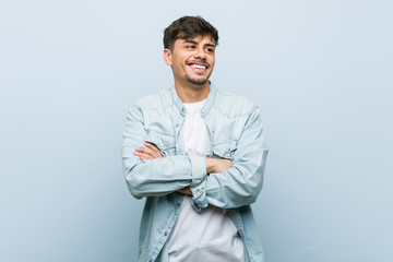 Young hispanic cool man smiling confident with crossed arms.