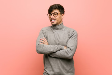 Young smart student man smiling confident with crossed arms.