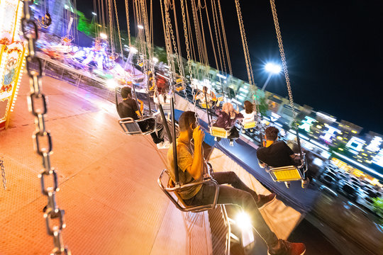 Swinging in theme park at fully lights night