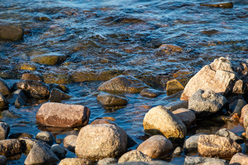 Fototapeta na wymiar big stones in the evening on the ocean