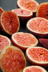 Ripe sweet figs on a black background.
