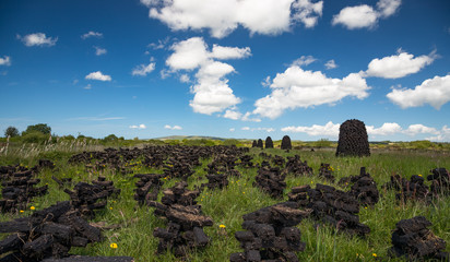 Pile of peat bog turf stacked up in field in rural county Kerry, Ireland, Scenic Irish landscape