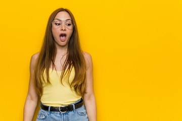 Young redhead ginger woman with freckless being shocked because of something she has seen.