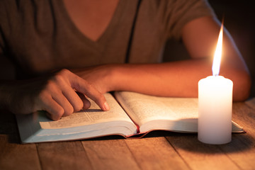 Poor children read books using candles for lighting., Disadvantaged Children doing homework, Education Concept.