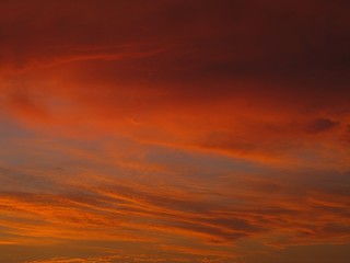 An orange evening sky with clouds