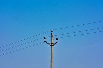 Concrete electric pole with blue sky background