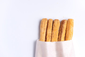 Crispy bread sticks with cheese  on white 