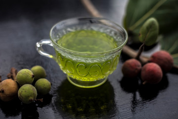 Detoxifying herbal ayurvedic banyan tree tea or Indian wishing tree tea in transparent glass cup...