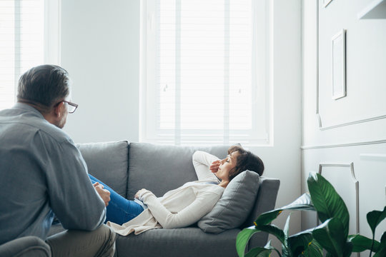 Woman At Therapy Room, Laying On Couch, Discussing With Psychotherapist Her Problems