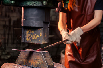 redhead ginger woman blacksmith portrait in workshop