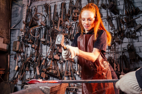 redhead ginger woman blacksmith portrait in workshop