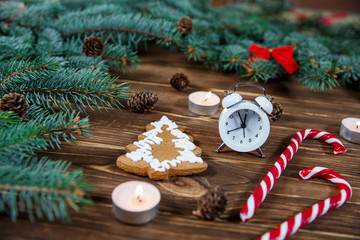 Christmas holiday background with alarm-clock, Candy canes wooden background. Close-up, top view.