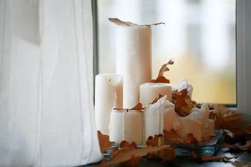 candles yellow leaves background autumn / abstract festive warm still life with candles