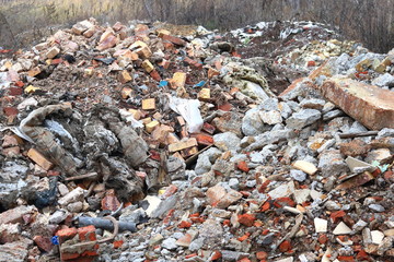 Construction waste with elements of various dismantled and destroyed old structures at municipal landfill