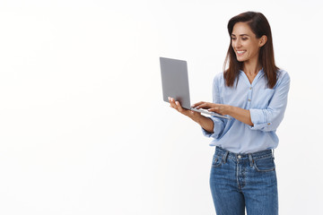 Lucky professional good-looking adult female entrepreneur writing text message coworker, smiling...