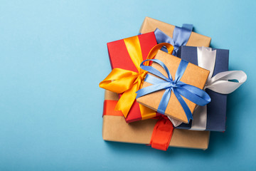 Stack of gifts on a blue background. Gift concept for a loved one, holiday, Christmas. Flat lay, top view