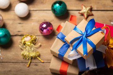 Stack of gifts, Christmas-tree decorations on a wooden background. Holiday concept, christmas, christmas eve. Flat lay, top view