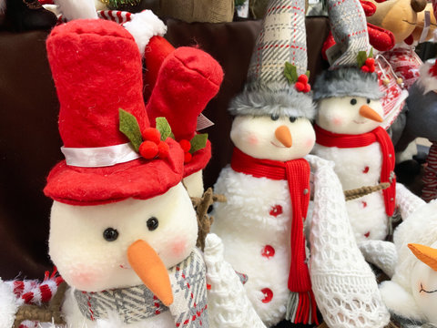 Decorative textule funny snowmen on a shelf at christmas market fair in mall