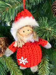 Christmas toy smiling Santa Claus in red clothes on a fir tree as a symbol of new year and christmas celebration and gifts