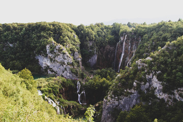 Plitvice Lakes National Park. Croatia’s most popular tourist attraction. Small rivers, waterfalls  and lakes in the forest. Natural beauty mountainous region. Pedestrian routes. Summer. Europe.