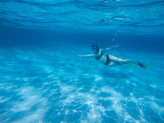 Fototapeta na wymiar Diving in the red sea. Sexy girl in bikini and mask. Snorkeling. Traveling lifestyle. Water sports. Beach holidays.